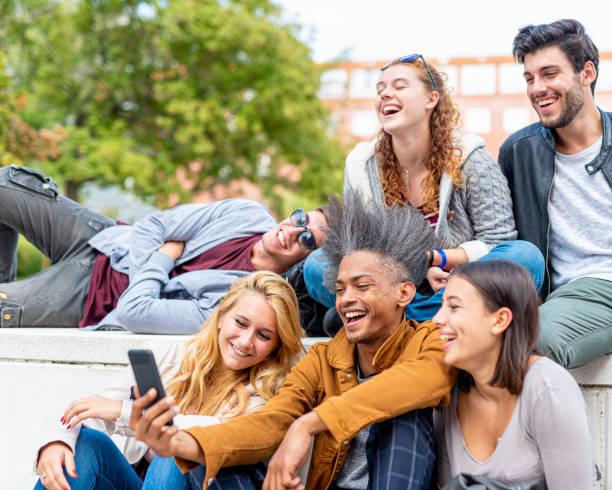 istock multiracial group of students watch multimedia content on a smart phone, millennials have fun on social networks, six people outdoors, concept of cultural diversity and youth aggregation 1286697078