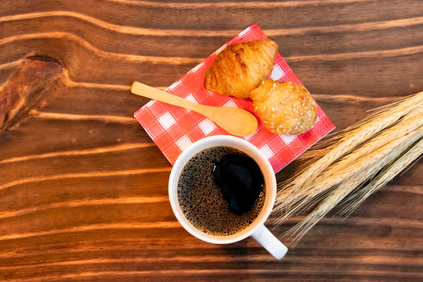 istock coffee served in mug and small croissant on wood 1286697239