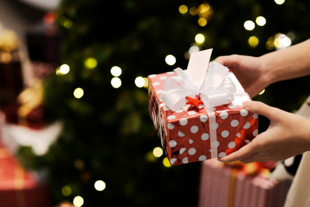 istock Girl holding a red gift box on christmas day 1286698688
