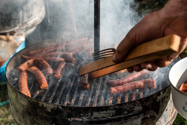 istock Sausages on smoking Barbecue Grill in garden or backyard 1286699875