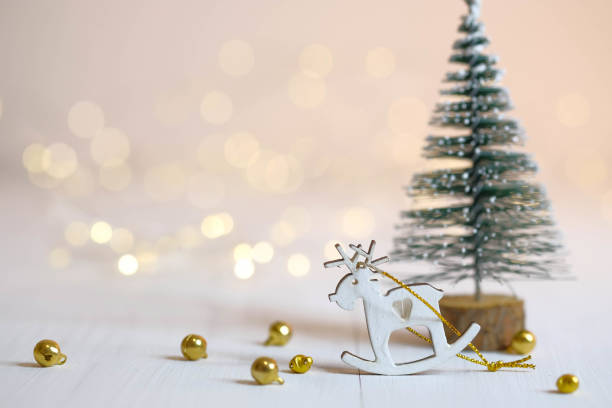 istock Deer figurine, Christmas tree and golden balls on the table. 1286700166