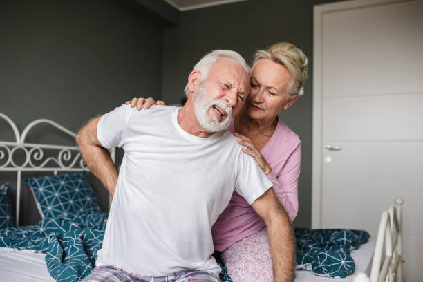 istock Senior man suffering from back pain in bed 1286701816