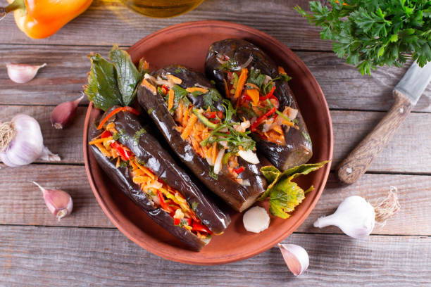 istock Eggplant slices stuffed vegetables in a plate on a table. Top view 1286701863