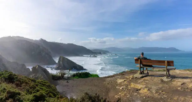 A man relaxing and enjoying the vie at the cliffs of Loiba in Galicia