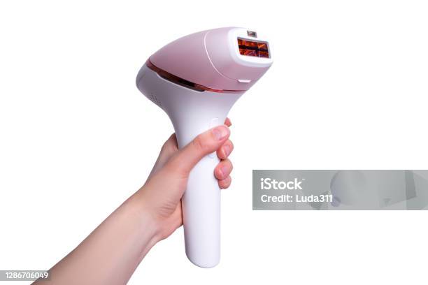 The Girl Holds A Photoepilator In Her Hand A Device For Removing Unwanted Hair Isolated On White Stock Photo - Download Image Now