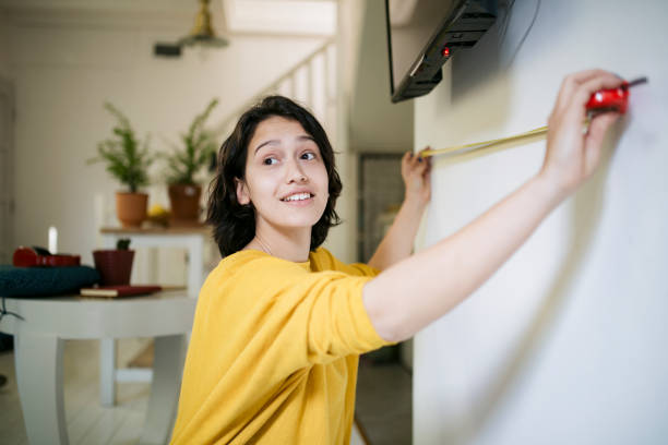 istock Cheerful young Caucasian woman improving her home 1286707250
