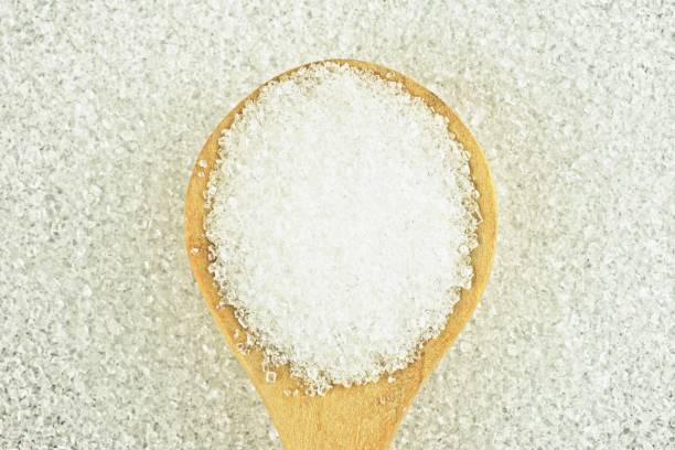 istock Sugar in round wooden spoon. 1286707305