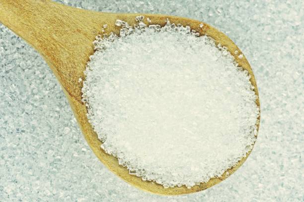 istock Closed up Sugar in wooden spoon. 1286707549