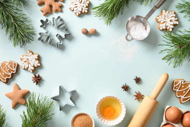 istock Christmas gingerbread cookies with ingredients for cooking on blue. Copy space 1286707669