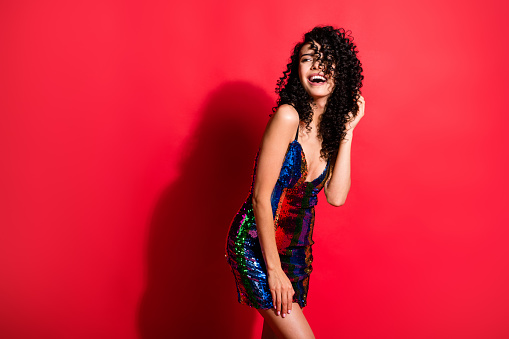 Portrait of stunning cheerful wavy-haired girl having fun disco bachelorette isolated on bright red color background.