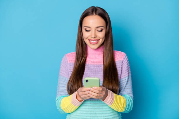 istock Close-up portrait of pretty focused cheery girl using device browsing web chat roaming isolated over bright blue color background 1286710613