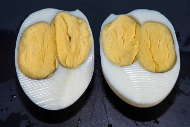 istock An egg with two yolks. Double yolk hard boiled egg. Close-up of an egg with two yolks 1286710694