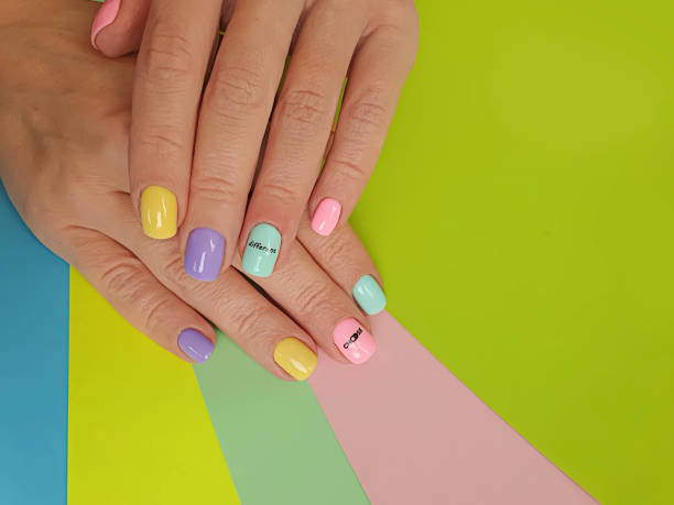 istock female hand beautiful manicure on a colored background 1286712025