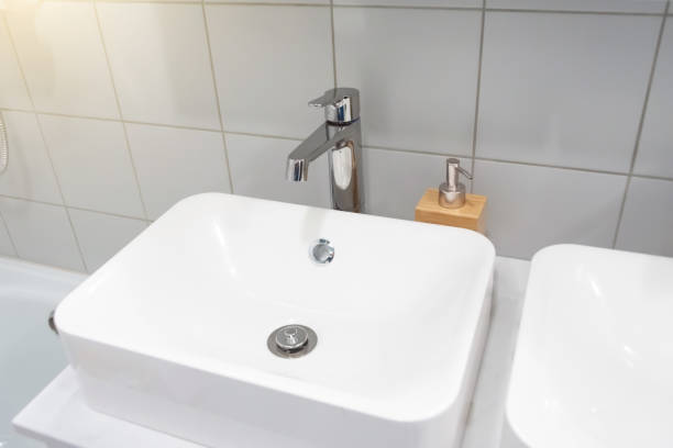 istock Modern bathroom interior with metal faucet and ceramic white sink. 1286712042