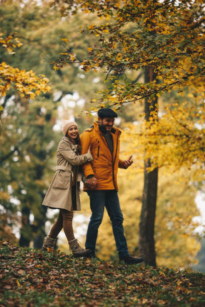 istock Smiling couple walking. Autumn forest. 1286712176