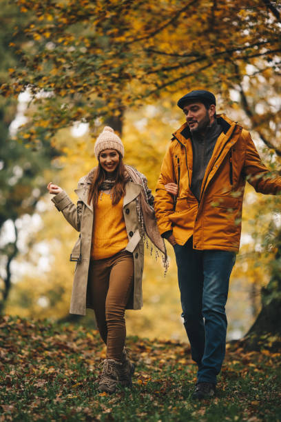 istock Young couple walks in Autumn forest. 1286712792