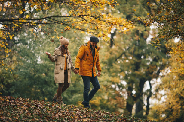 istock Wife follows her husband trough forest. 1286712898