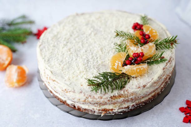 istock Christmas food fruit cake, covered winter greenery, decorative berries and tangerines 1286712946