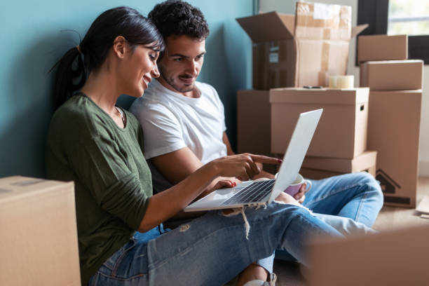 istock Attractive young couple looking decoration ideas with laptop while taking a break sitting on the floor at home. 1286713928