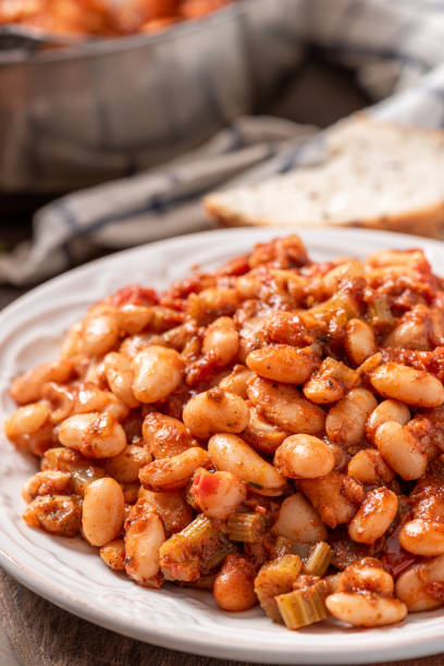 istock White beans with spicy tomato sauce in a white ceramic plate close-up. 1286716315