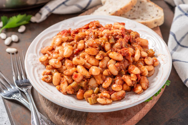 istock White beans with spicy tomato sauce in a white ceramic plate close-up. 1286716350