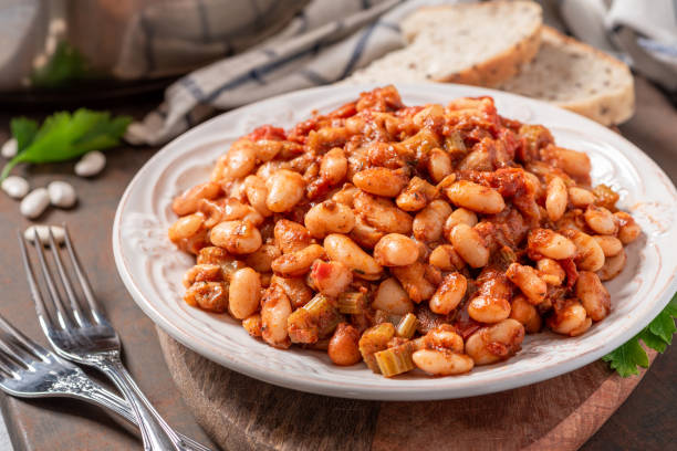 istock White beans with spicy tomato sauce in a white ceramic plate close-up. 1286716374