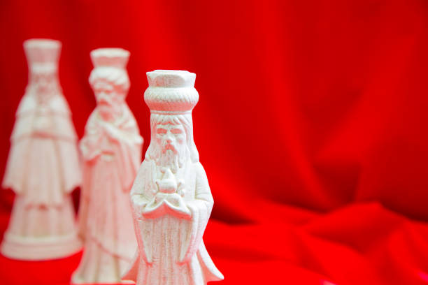 Adoration: Three wise men, camel, and baby Jesus figurines on white background