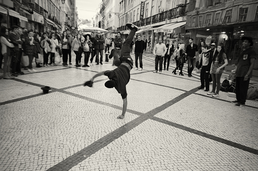 Lisbon, Portugal - January 23, 2016: A hip-hop dancer performs in the Rua Augusta street in Lisbon downtown.