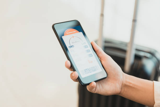 istock Female hand holds smart phone with boarding pass on screen 1286720478
