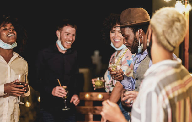 istock Cheerful multiracial people dance together while wearing surgical face mask under the chin - Home private party 1286723128
