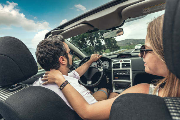 istock Couple traveling on a convertible car 1286723163