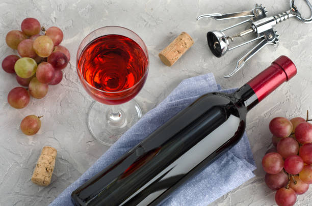 istock Wine and bunches grapes on gray background 1286723234