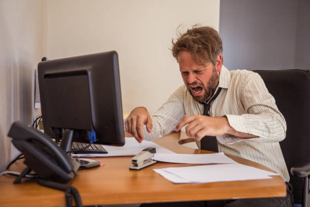 istock Man at desk staples his finger by accident 1286728583