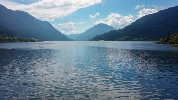 istock Weissensee - An idyllic view on the lake surrounded by the mountains from each side 1286728657