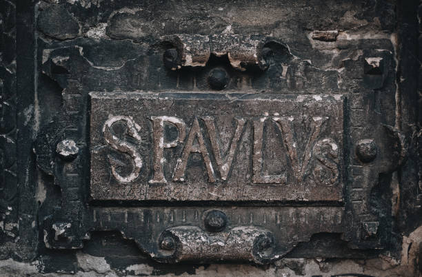 istock The inscription in Latin translated into English means - St. Paul. An architectural element under the bas-relief of the Boim Chapel. Old carvings on the surface of alabaster. Lviv, Ukraine. 1286728728