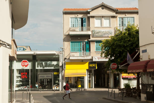 Limassol, Cyprus, November 9th, 2020: A street in the Old town with a pedestrian in a protective face mask