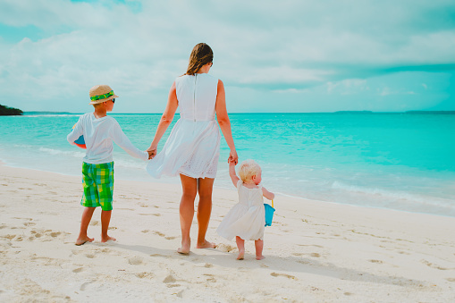 mother with son and daughter on beach vacation