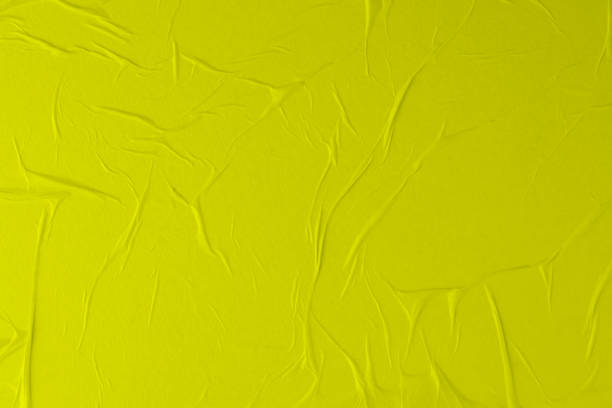 istock Crumpled yellow paper. Empty street poster texture. 1286735689