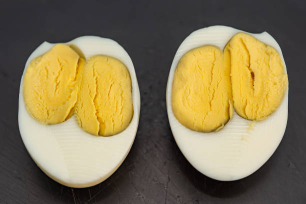 istock An egg with two yolks. Double yolk hard boiled egg. Close-up of an egg with two yolks 1286738179