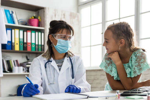 istock A pediatrician examines a child during a COVID 19 pandemic 1286738455