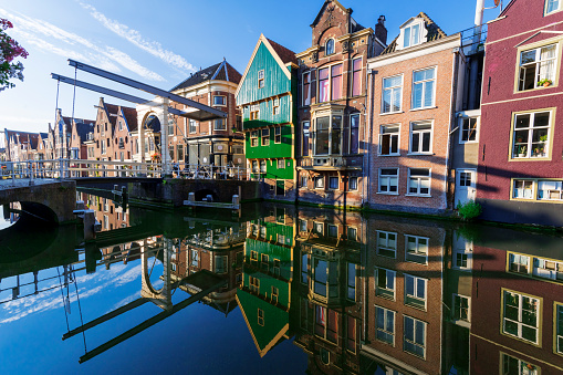 Houses built under 17th century architecture along a canal with a small bridge in Alkmaar, Netherlands