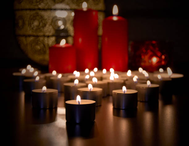 istock Many burning tealight candles stock images 1286739831