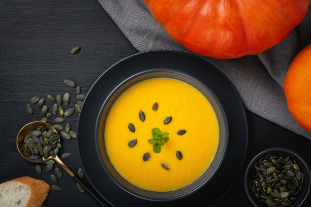 istock Vegetarian autumn pumpkin cream soup with seeds. Top view with copy space 1286740747