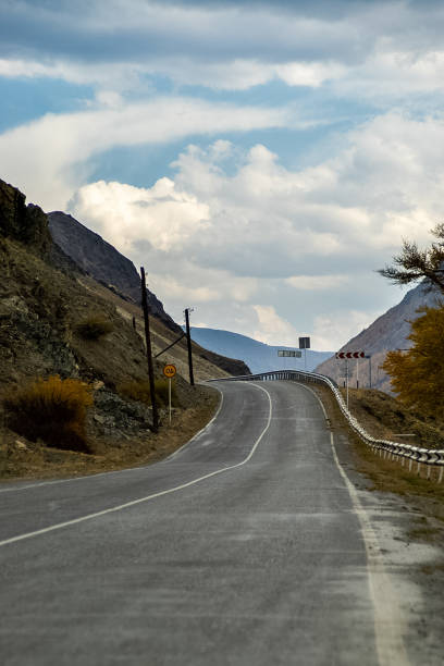 carretera de asfalto a las montañas. pista de montaña en altai. - country road lane road dirt road fotografías e imágenes de stock