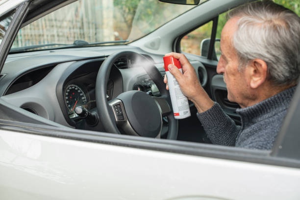 istock Man Spraying Disinfectant on His Car 1286743286