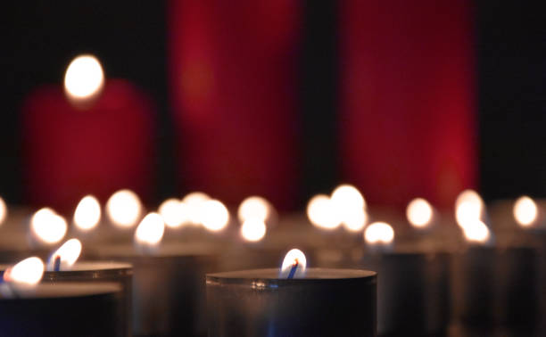 istock Many burning tealight candles stock images 1286743569