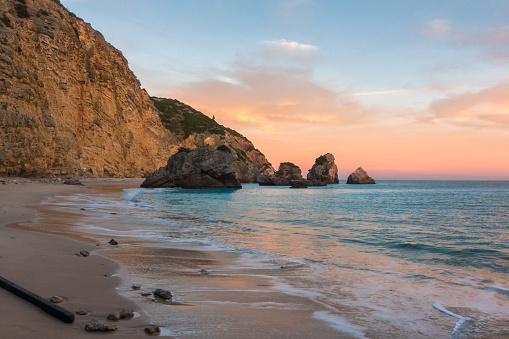 Ribeiro do Cavalo paradise beach in Arrabida Natural Park in Sesimbra at sunset, Portugal