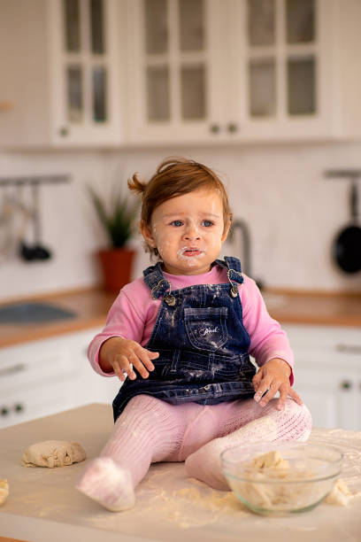 istock Child littered in flour in the kitchen 1286744813