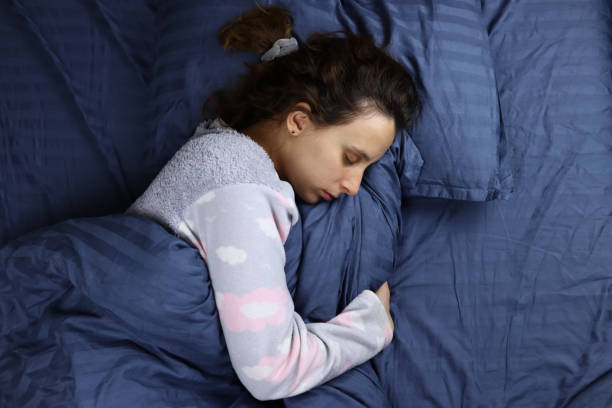 istock young woman sleeping on a pillow in bed 1286745046