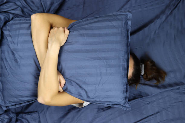 istock Young girl sleeping hugging a pillow 1286745758